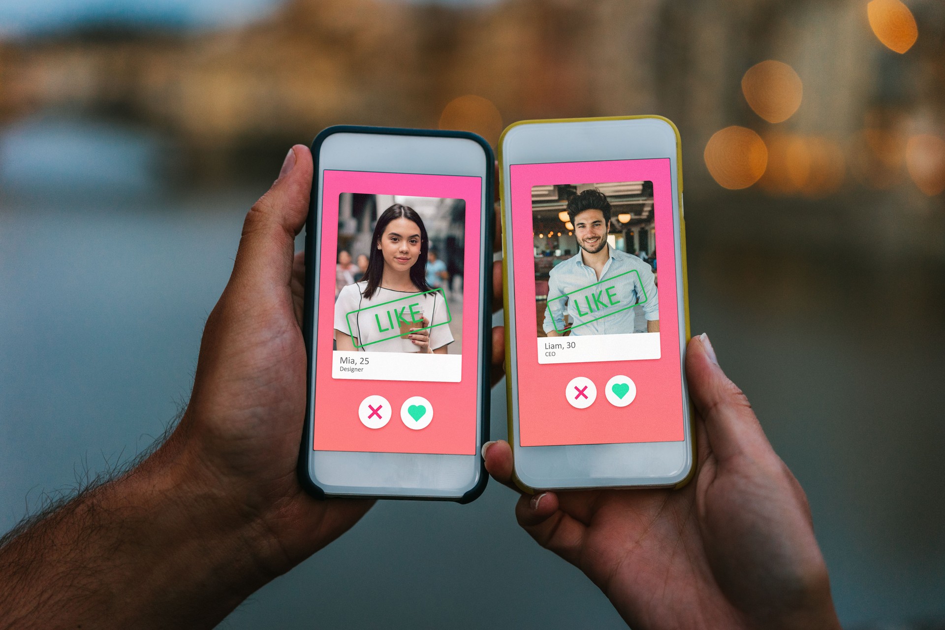 Conceptual image of two hands holding smart phones with an online dating app on the screen